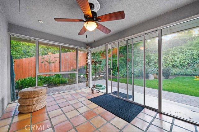 Light and bright sun room with floor to ceiling windows with view and access to backyard.