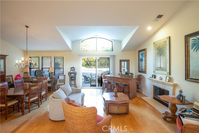 vaulted ceiling living room with fireplace