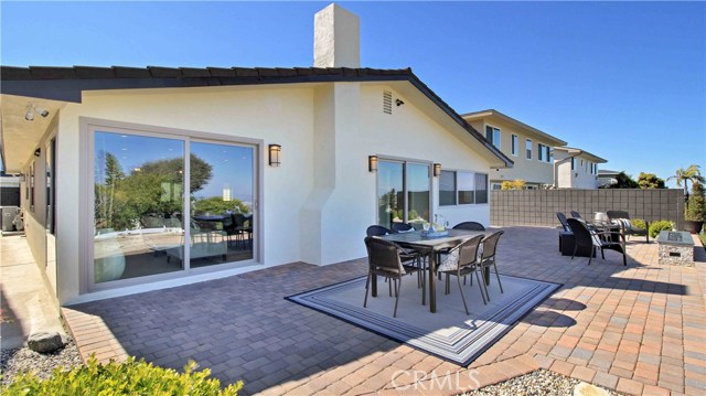 very attractive paver patio, notice the security cameras at each corner of the house.