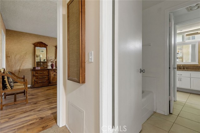 Looking into main bedroom from upstairs hallway and into bathroom at right.