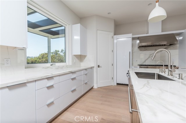 Stunning kitchen with bright natural sunlight and views with awning that opens to large balcony