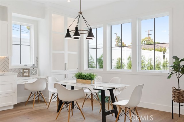 Breakfast dining area, built in desk space and full height cabinety with interior lighting