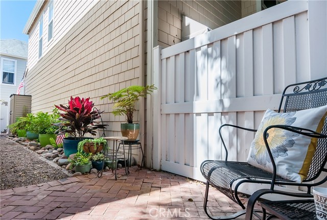 The side of the home includes a luscious alley and gravel path, perfect for a dog run!