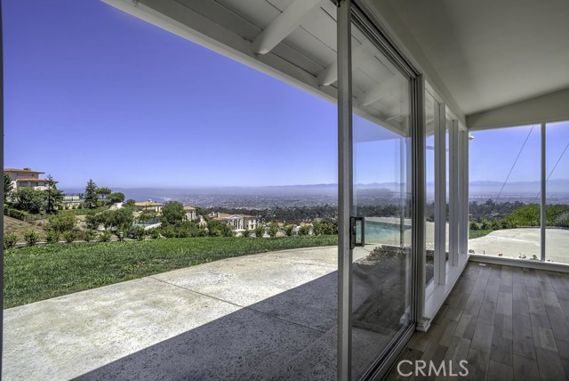 Sliding glass doors leading to the backyard with views.