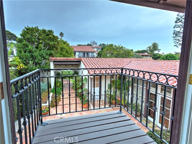 Balcony off upstairs bedroom overlooks courtyard