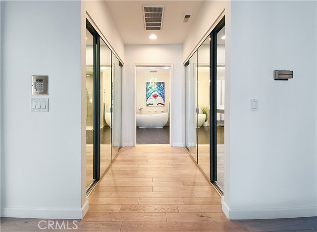 Dual closets flank the hall to the master bath.