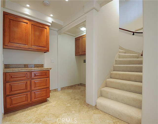 Stairs down to lower level and laundry area and storage