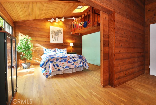 View of bedroom 3 with loft with wood sliding divider door