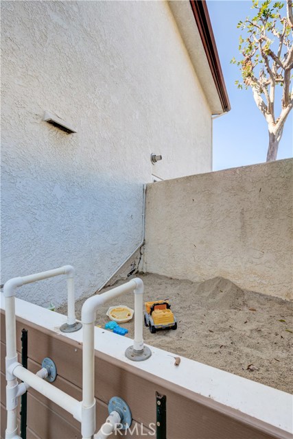 Tucked away on the side of the house is a fun sandbox.