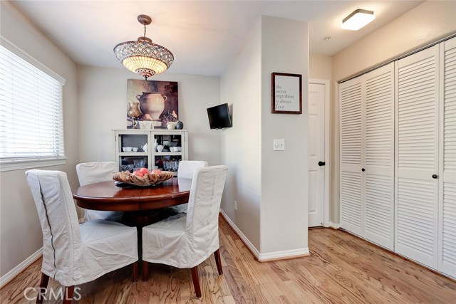 Cozy breakfast nook area and adjacent laundry area with louvered doors.