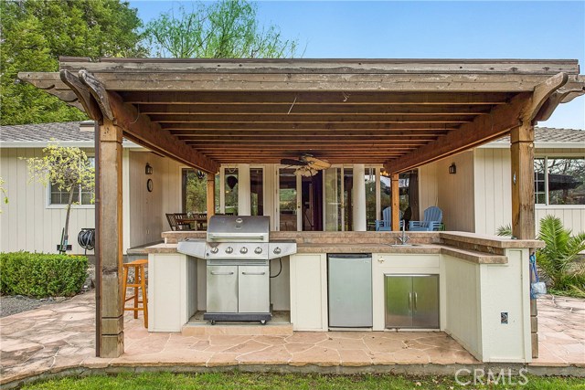 Outdoor kitchen with mini-fridge, sink & bbq