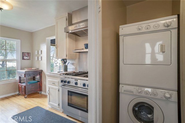 FRONT HOUSE KITCHEN WITH A GORGEOUS THERMADOR GAS STOVE AND WALK IN PANTRY/ LAUNDRY ROOM.