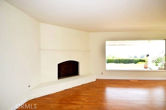 Living room with large feature wall fireplace and large picture window to the glorious vistas.