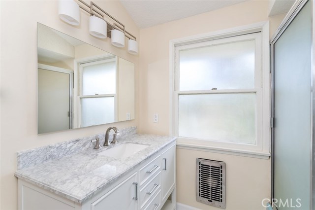 Full bath with carrara marble vanity top