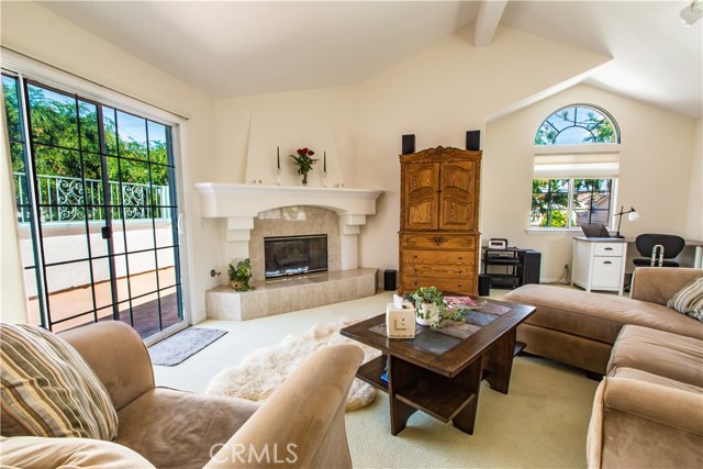 High vaulted ceilings with neutral colors make this living room cozy and relaxing