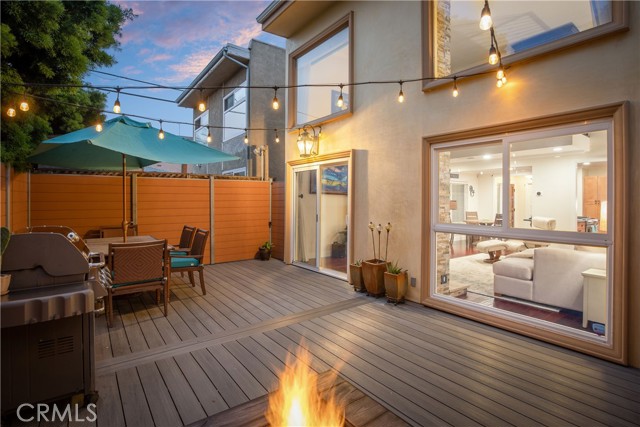 The living space opens to the backyard for an ideal indoor/outdoor lifestyle while enjoying the natural gas fire pit, newer patio deck and fencing, and sparkling lighting overhead - the perfect outdoor space that’s ready for you to entertain, play, or relax all year long.