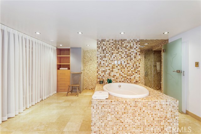 Dressing area with closet space and luxurious spa like bath