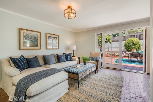 Family room with brick floor and bar area opens to back patio