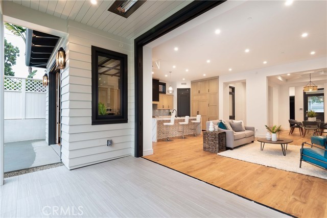 The 14' Cantina Door opens to the back yard patio with Porcelain tile to further expand your living area and allow the cool ocean air to flow through the home. Built in heaters above let you stay outside during cooler evenings.