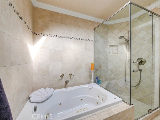 Seperate tub and shower with travertine in the ensuite master bath.