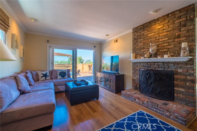 Living room with fireplace and sliding door to the outside.