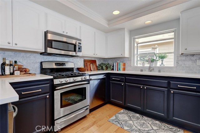 Updated kitchen includes Quartz counter tops and tile backsplash.