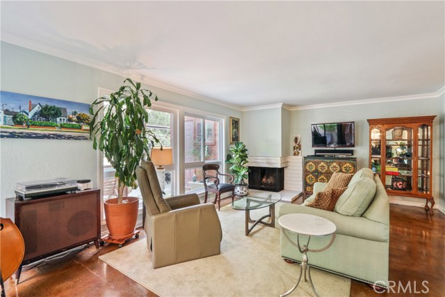 Spacious living room with fireplace overlooking private patio