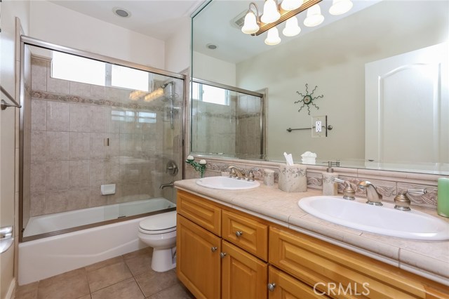 Upstairs Hall bath: shower in tub, dual sinks, Italian tile flooring