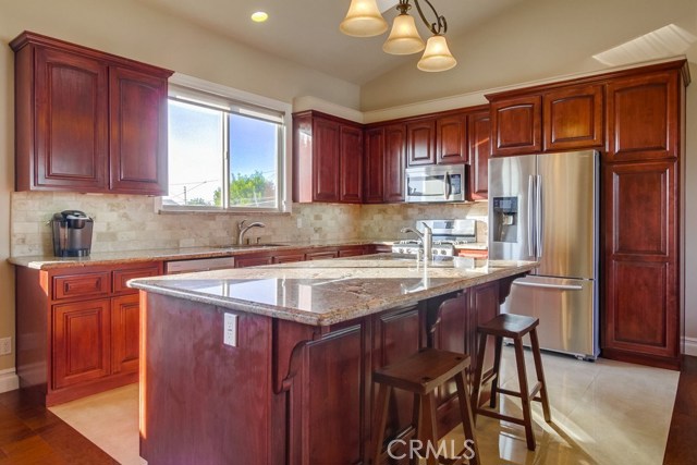 Granite counters, wood cabinets, stainless appliances (refrigerator included) and tile floors make up this wonderful cook's kitchen