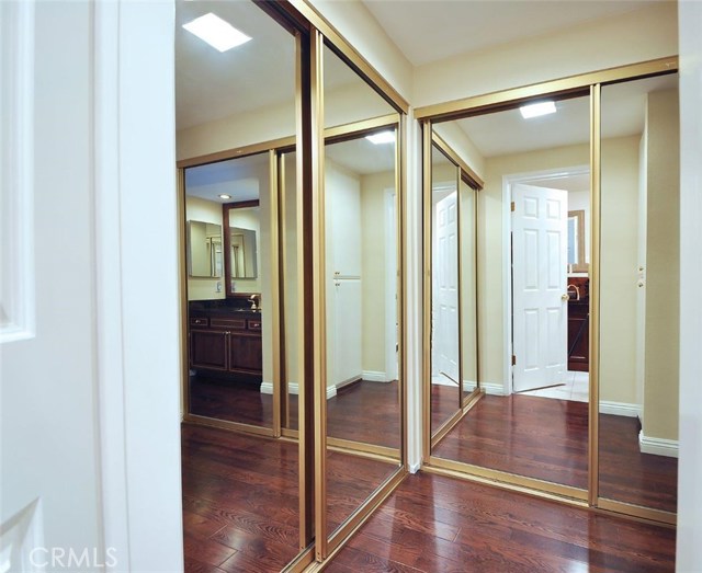 Master suite dressing area. Mirrored wardrobes with closet organizers.