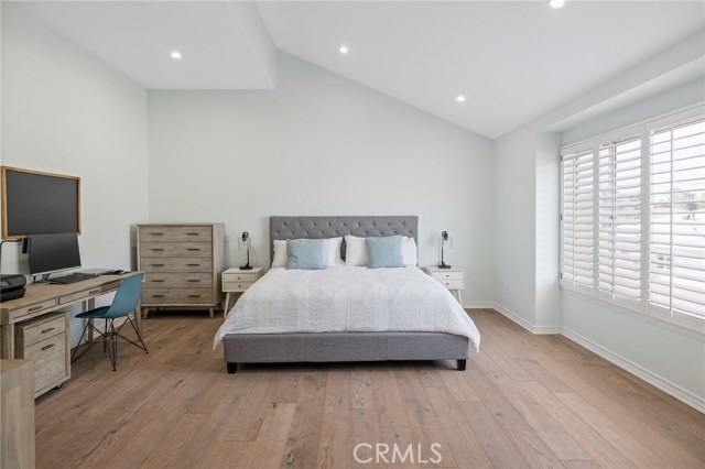 Master bedroom with vaulted ceilings & wood shutters