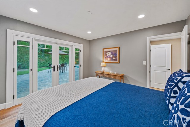 Upstairs guest bedroom with French doors to the entertainer's yard.