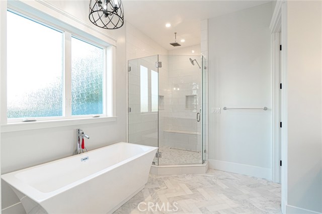 Master-suite bathroom. Soaking tub and walk-in shower with multiple shower features.