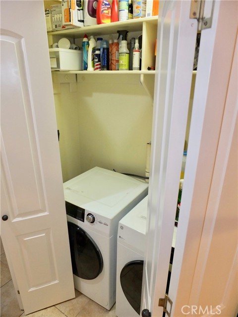 Full size washer & dryer located in hallway between Living Room and Primary Bedroom.