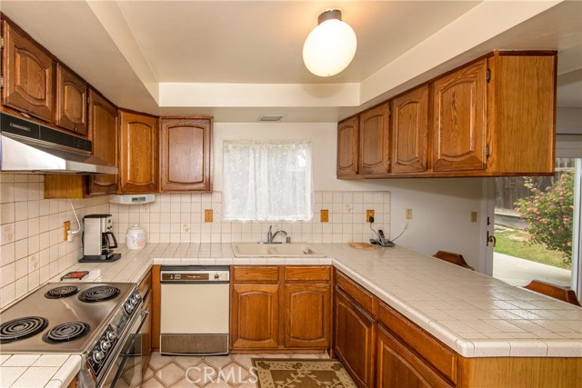 More of the kitchen showing the electric stove.