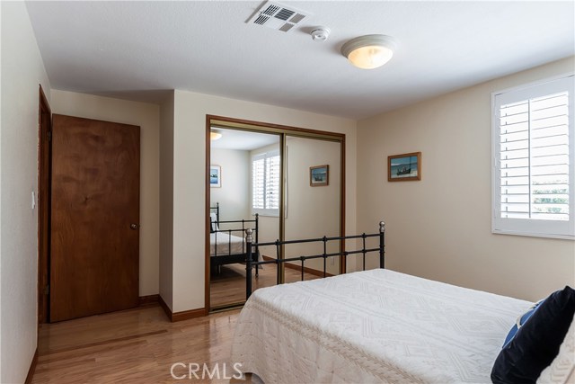 1st level bedroom #1. Smooth ceilings, plantation shutters.
