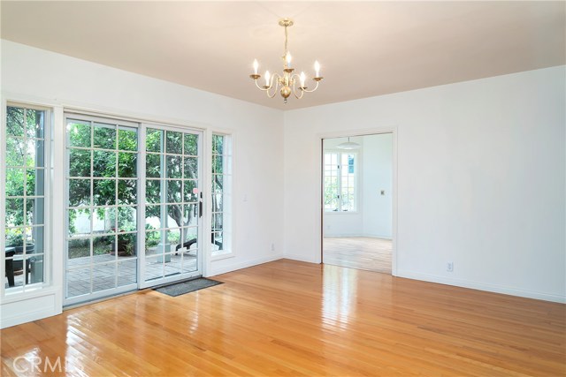 Far corner of family room looking towards kitchen and nook with newer laminate floor.