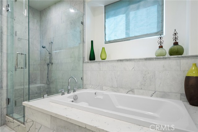 The primary bathroom also has a separate spa tub and shower