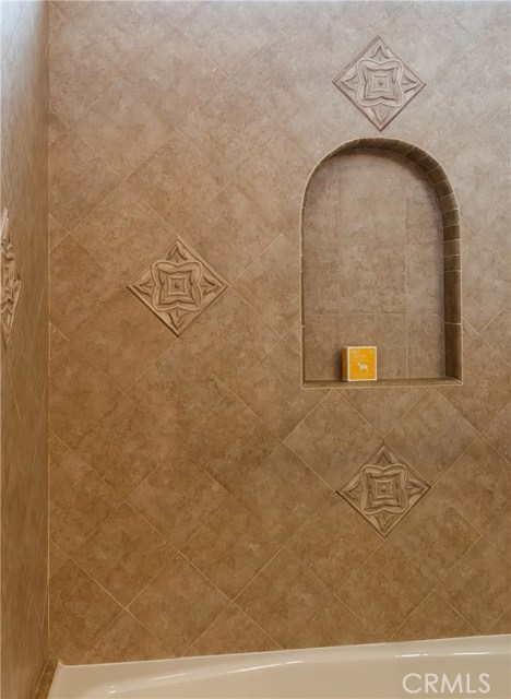 The bath features beautiful tile detailing.