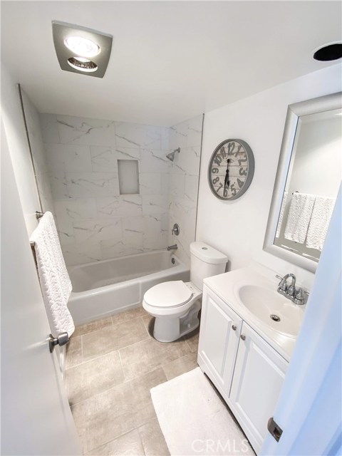 Upstairs bathroom with ceramic tub and full vanity