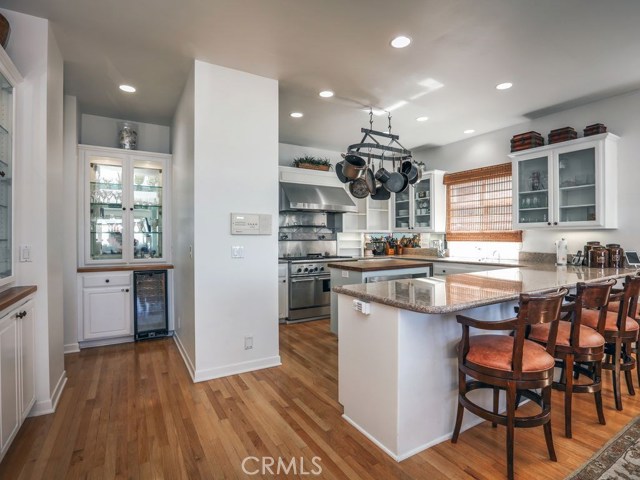 The kitchen is complete with professional stainless steel appliances including oven/stove, fridge, dishwasher, warming drawer and wine fridge.