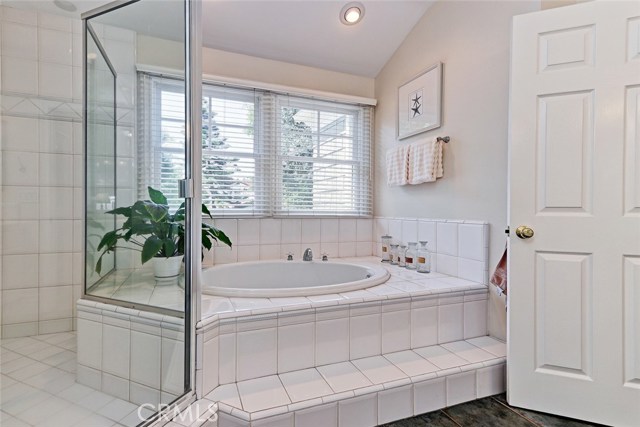 Separate enclosed shower next to soaking tub.