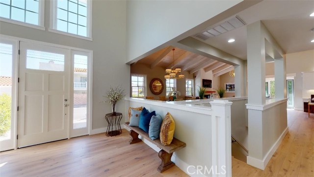 Enter the front door into the formal foyer which has 25ft high tung and groove exposed beam ceiling. Notice the detailed level of trim and moldings throughout. Windows bring in the natural beach sunlight. This open floorplan creates a large expansive feeling