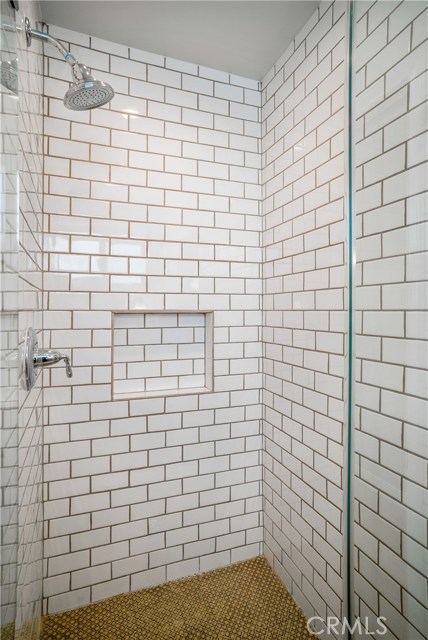 Master shower. Custom heated flooring and again, the detail in the tiles are artfully inlaid. Go ahead.. get all sandy at the beach. No problem here.