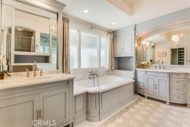 Recently remodeled master bath with double sinks, vanity area, separate tub and all glass shower.