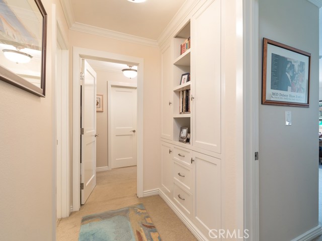 Beautiful custom cabinetry and moldings highlight the hallway.