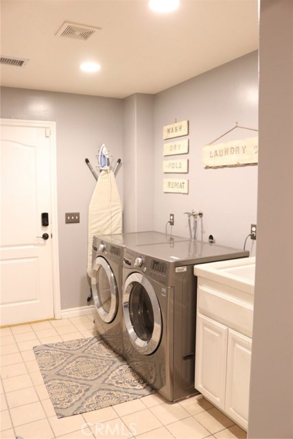 Large laundry room.  Includes a counter and sink.