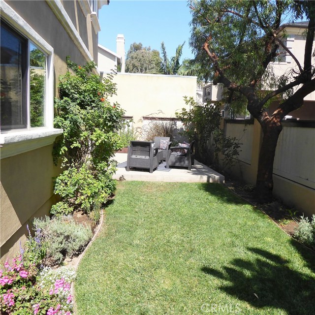 A sunny, private yard with a patio and herb garden