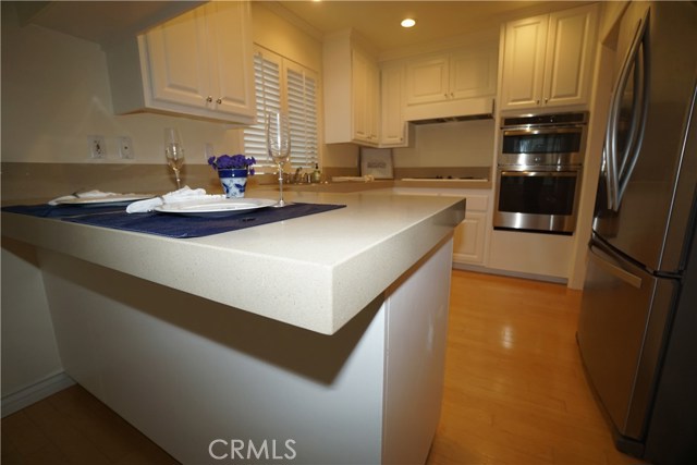 Kitchen opens to large dining room across breakfast bar.