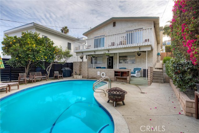 Backyard sparkling pool with view of the main house.